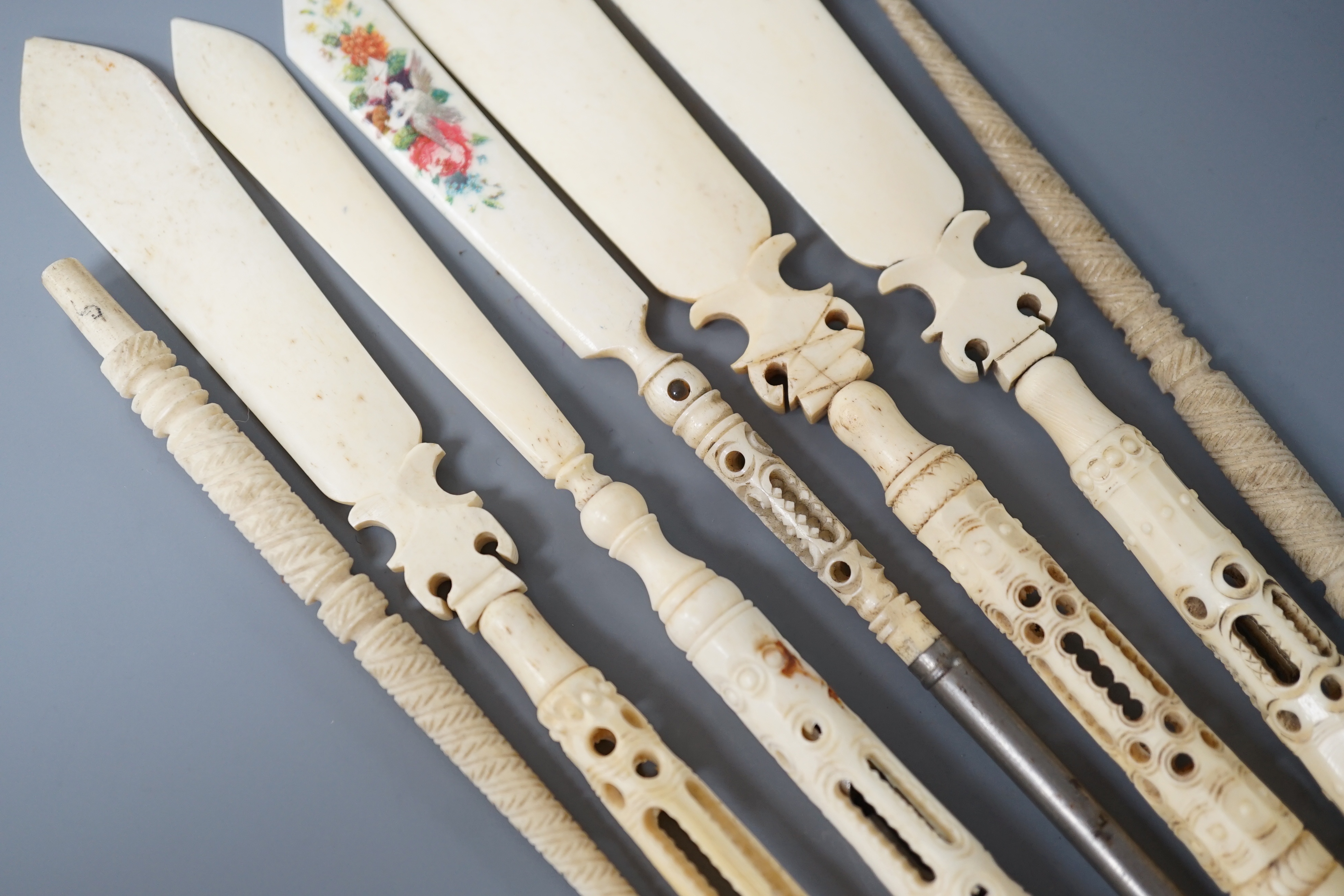 Four Victorian bone Stanhope paper knives, and three other bone items